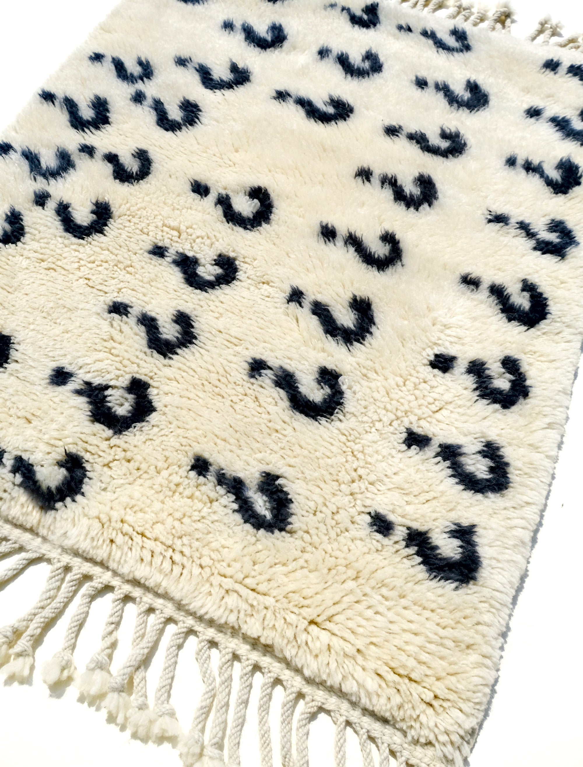 Experience the ultimate comfort with our 'Ivory Enigma Rug: Super Soft Playful Question Marks in Black Yarn.' Crafted for coziness, this rug showcases a delightful pattern of playful question marks in black yarn on an ivory background. Its irresistibly fuzzy texture adds a touch of luxury to any space, making it a perfect addition to your home. Elevate your décor with this charming blend of softness and whimsy.