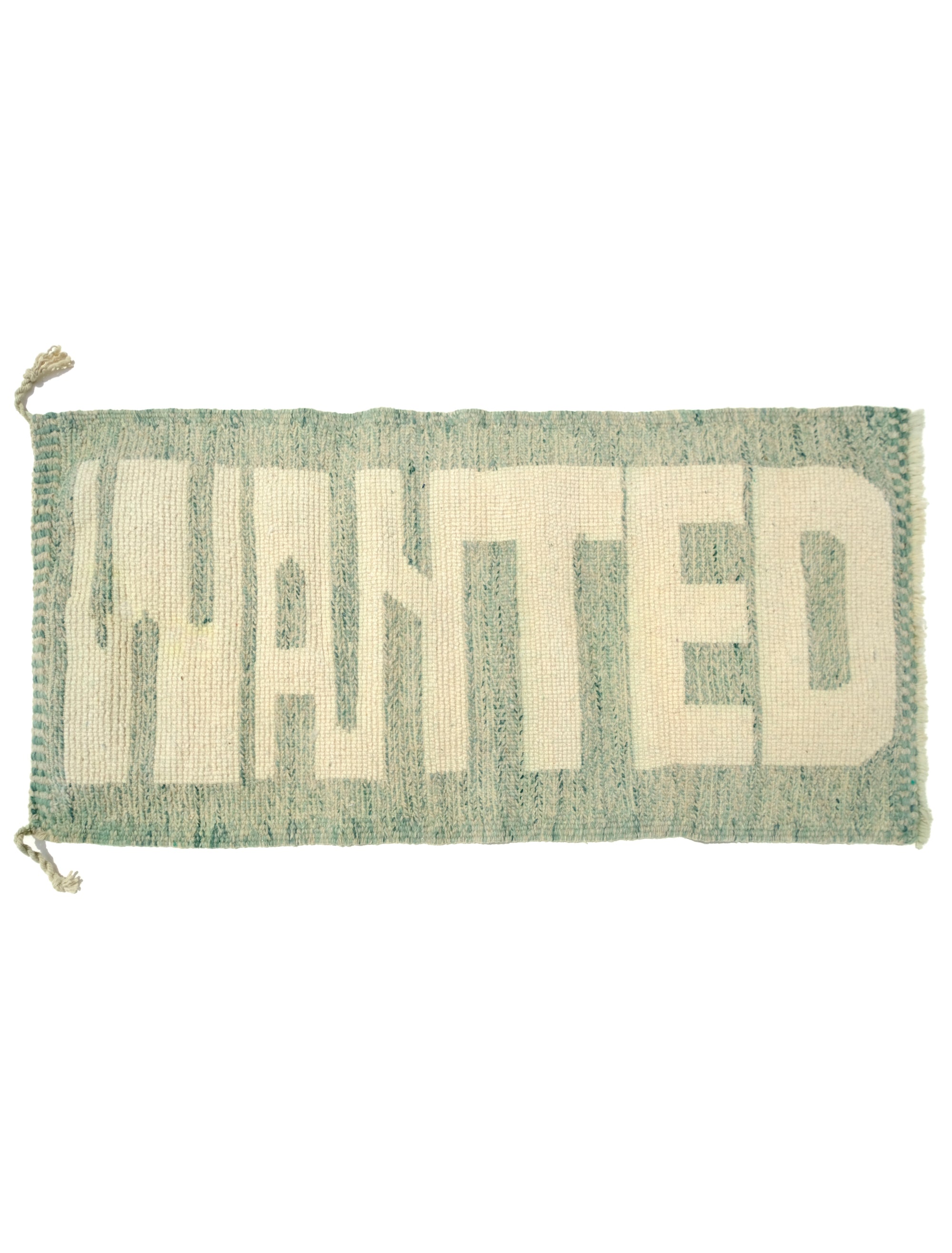 Discover the Reversible Ivory Green Whispers Rug, a truly unique and versatile piece handmade by Berber women in the Atlas Mountains. With its fuzzy 'WANTED' lettering on one side and a calming mix of pale green shades on the other, this rug adds an elegant touch to your decor while spreading a positive message. Explore the beauty of reversible design in this exceptional handmade creation.