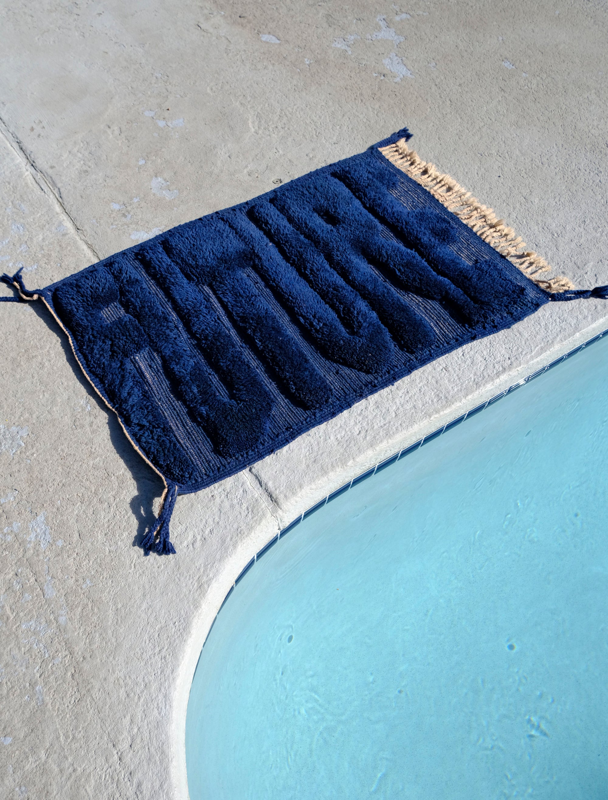 Transform your space with our 'Midnight Future Rug,' a stunning navy wool rug adorned with the enigmatic word 'FUTURE.' Its flat weaving base and captivating design add a touch of modern mystique to your decor. Elevate your ambiance with this rug that combines classic sophistication with contemporary flair.
