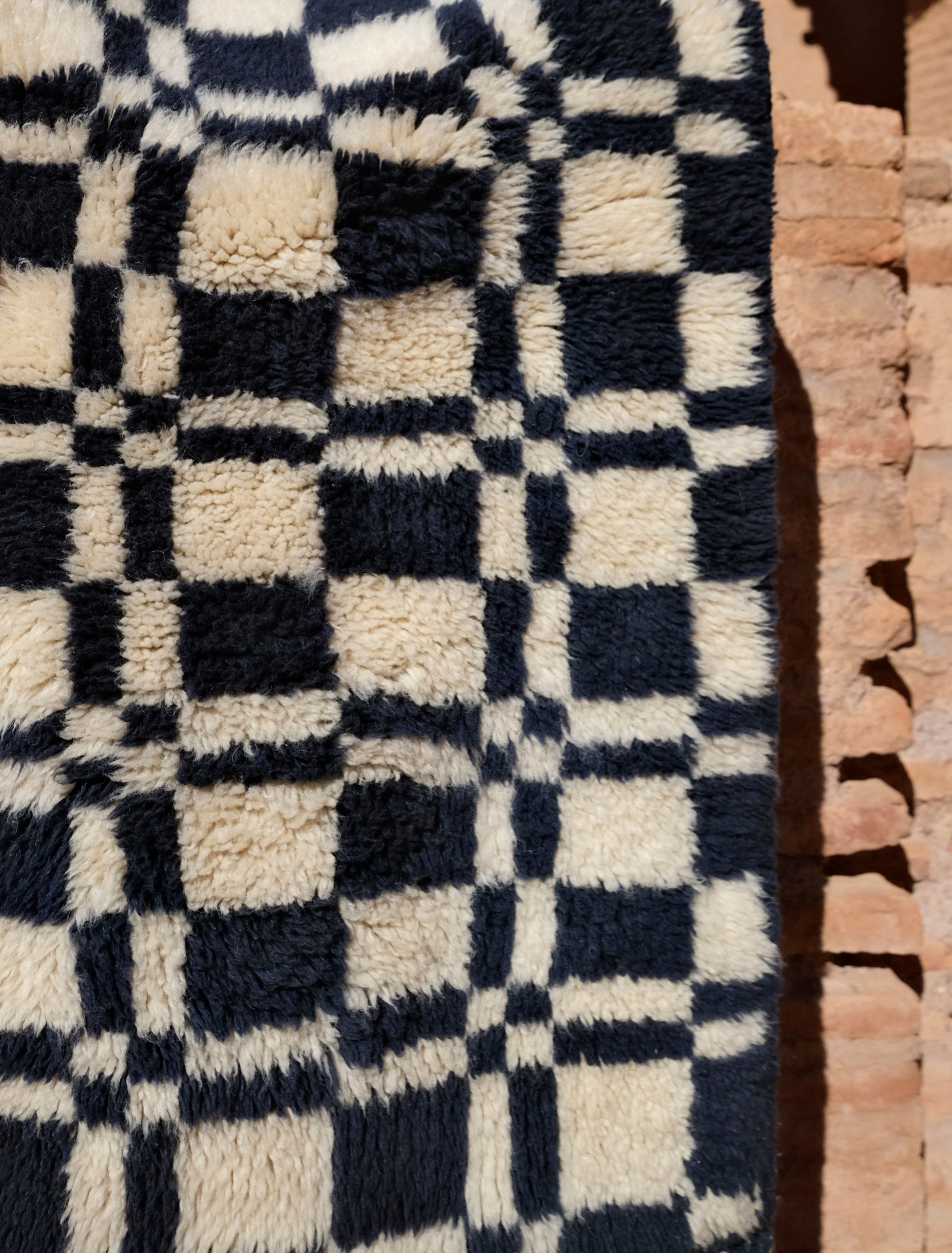 Discover the 'Navy Checkmate Rug' – a timeless blend of navy, ivory, and deep crimson in a classic checkerboard pattern. Elevate your space with this elegant, handcrafted piece that adds a touch of sophistication to any room. Explore our checkerboard collection for a stylish addition to your home decor.