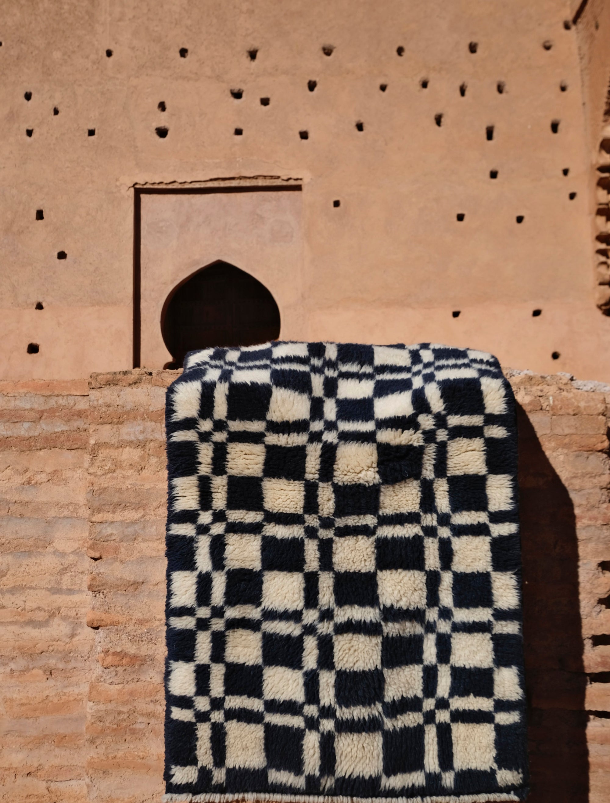Discover the 'Navy Checkmate Rug' – a timeless blend of navy, ivory, and deep crimson in a classic checkerboard pattern. Elevate your space with this elegant, handcrafted piece that adds a touch of sophistication to any room. Explore our checkerboard collection for a stylish addition to your home decor.
