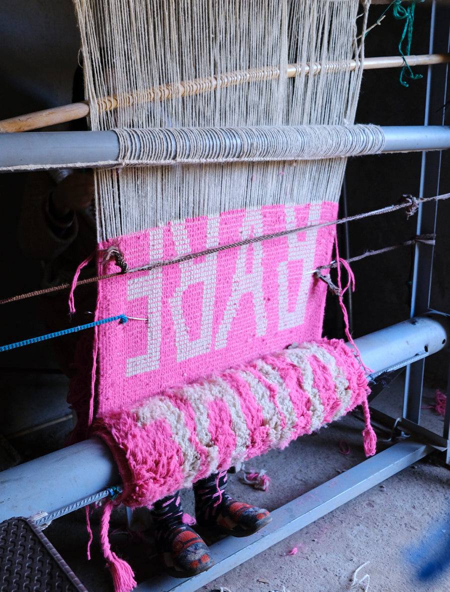 Meet our latest cushion made from a Beni Mrirt rug. Vibrant neon pink, adorned with the word "BABE" in white yarn, this 55x55cm delight effortlessly infuses joy into any space. It's not just decor; it's a celebration of style and comfort. Watch your room bloom with the playful charm of "Babe in Bloom," a vivid testament to the power of color and design.