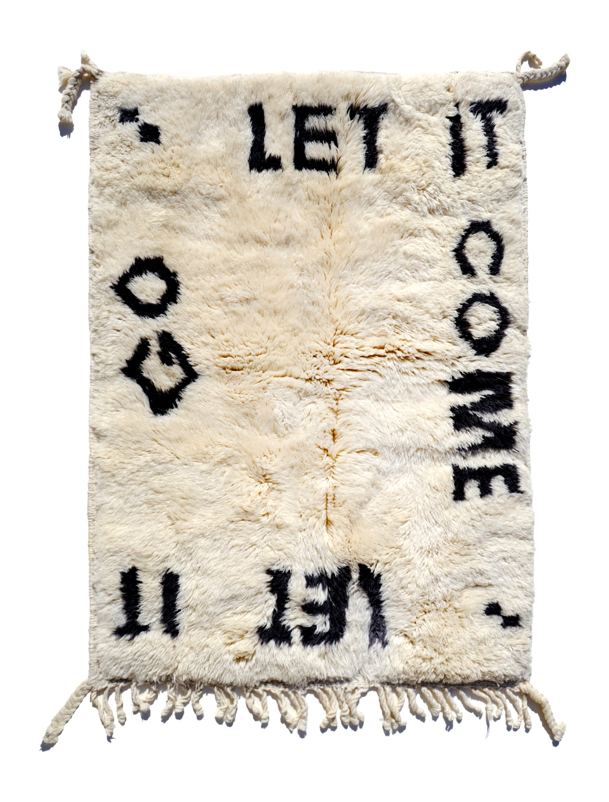 Indulge in comfort with our Ivory Serene Affirmations Rug, handcrafted in the Atlas Mountains. Its plush fibers offer a luxurious experience, while the subtle saying, 'let it come, let it go,' brings a calming touch to your space. Immerse yourself in Moroccan craftsmanship, transforming your home into a haven of tranquility.