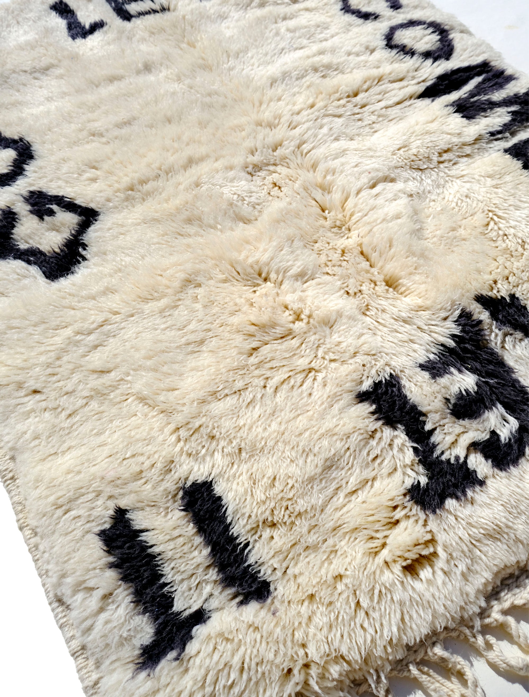 Indulge in comfort with our Ivory Serene Affirmations Rug, handcrafted in the Atlas Mountains. Its plush fibers offer a luxurious experience, while the subtle saying, 'let it come, let it go,' brings a calming touch to your space. Immerse yourself in Moroccan craftsmanship, transforming your home into a haven of tranquility.
