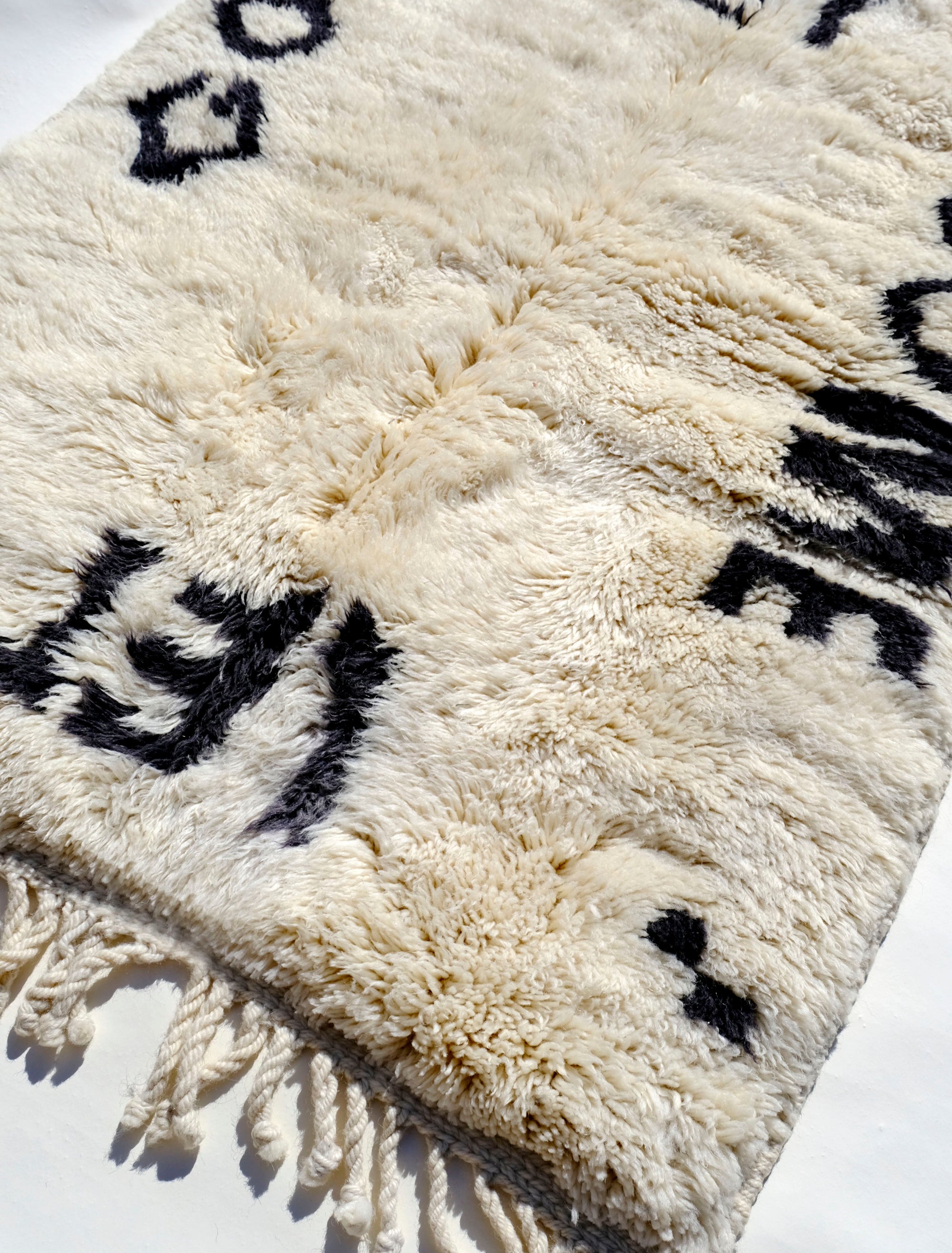 Indulge in comfort with our Ivory Serene Affirmations Rug, handcrafted in the Atlas Mountains. Its plush fibers offer a luxurious experience, while the subtle saying, 'let it come, let it go,' brings a calming touch to your space. Immerse yourself in Moroccan craftsmanship, transforming your home into a haven of tranquility.
