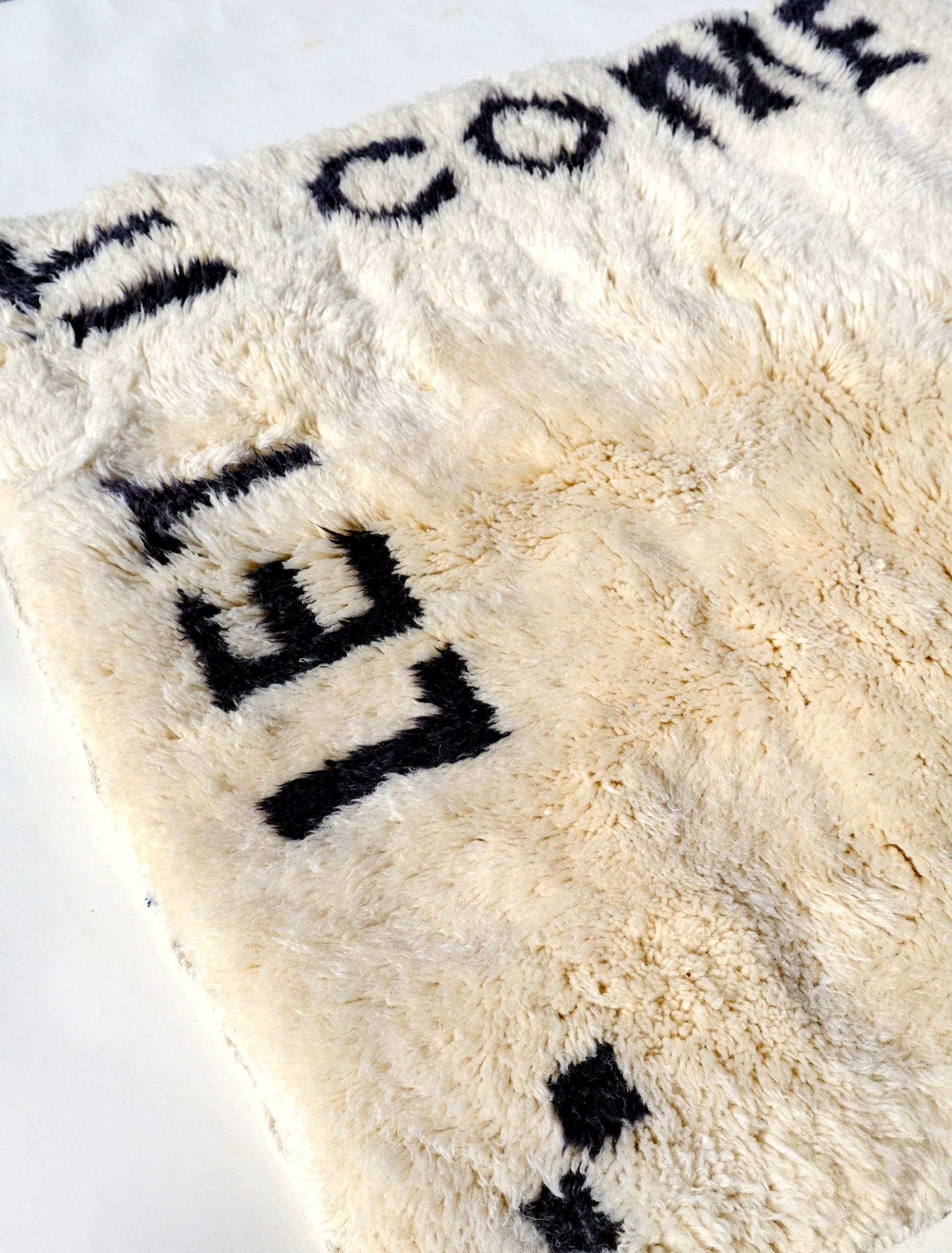 Indulge in comfort with our Ivory Serene Affirmations Rug, handcrafted in the Atlas Mountains. Its plush fibers offer a luxurious experience, while the subtle saying, 'let it come, let it go,' brings a calming touch to your space. Immerse yourself in Moroccan craftsmanship, transforming your home into a haven of tranquility.