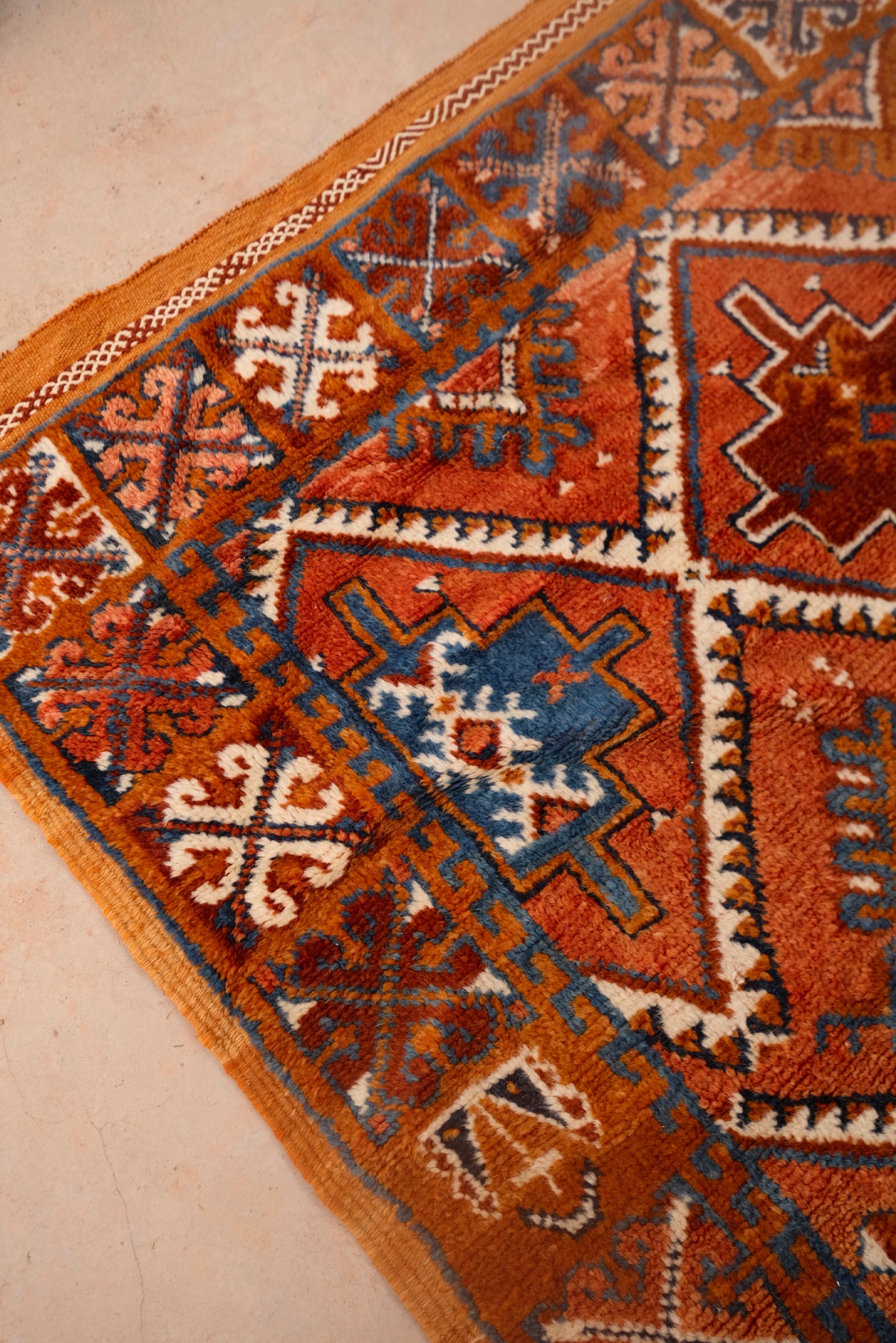  Explore unparalleled beauty with our Atlas Heritage Radiance Glawi Rug. Meticulously crafted using the highest weaving technique in the High Atlas Mountains, this museum-quality rug is a rare find. With natural dyes and a distinctive reddish-brown tone, this 50-year-old new, dead-stock piece is a unique testament to traditional craftsmanship. Limited availability.