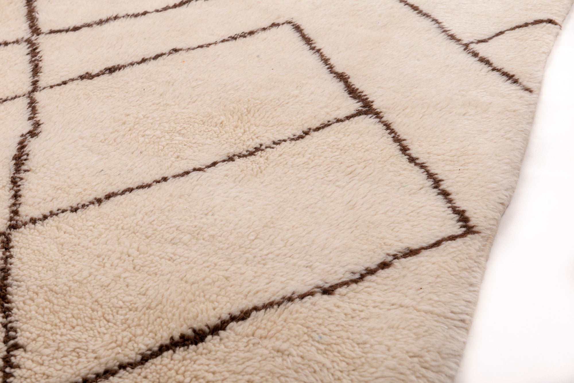 Elevate your space with our Ivory Crosshatch Beni Ourain Rug, featuring a classic ivory base with intricate crisscross brown lines meticulously handwoven in wool. Perfect for adding a touch of timeless elegance to your decor.