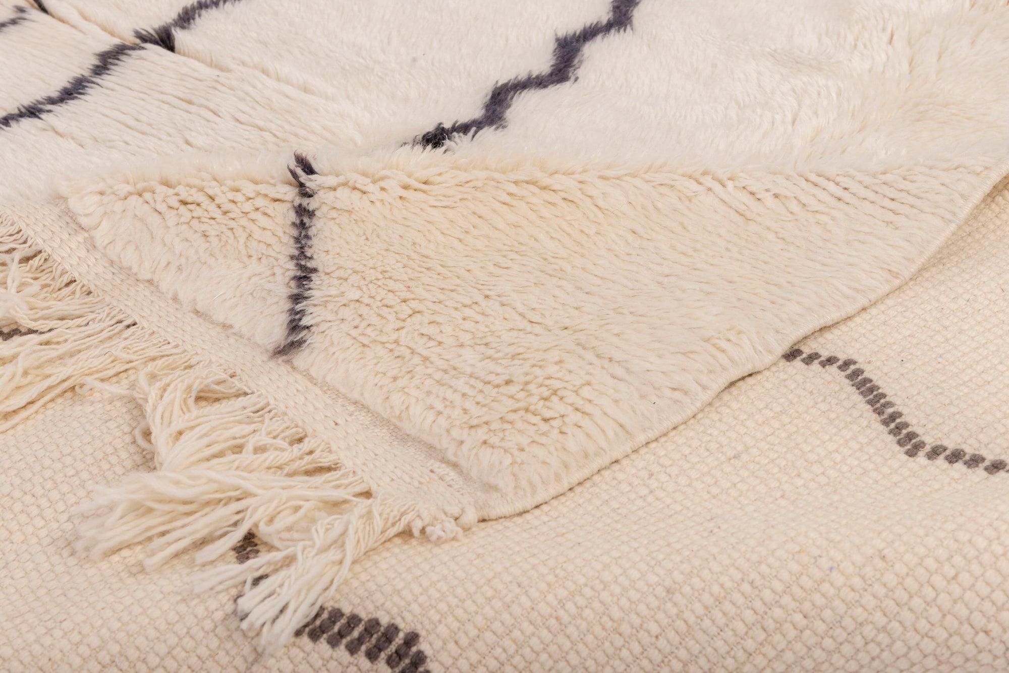 Elevate your space with our 'Ivory Streamlined Monochrome Rug.' Featuring a sleek ivory base adorned with black abstract lines, this rug effortlessly combines minimalistic design with modern flair, creating a captivating addition to your decor.