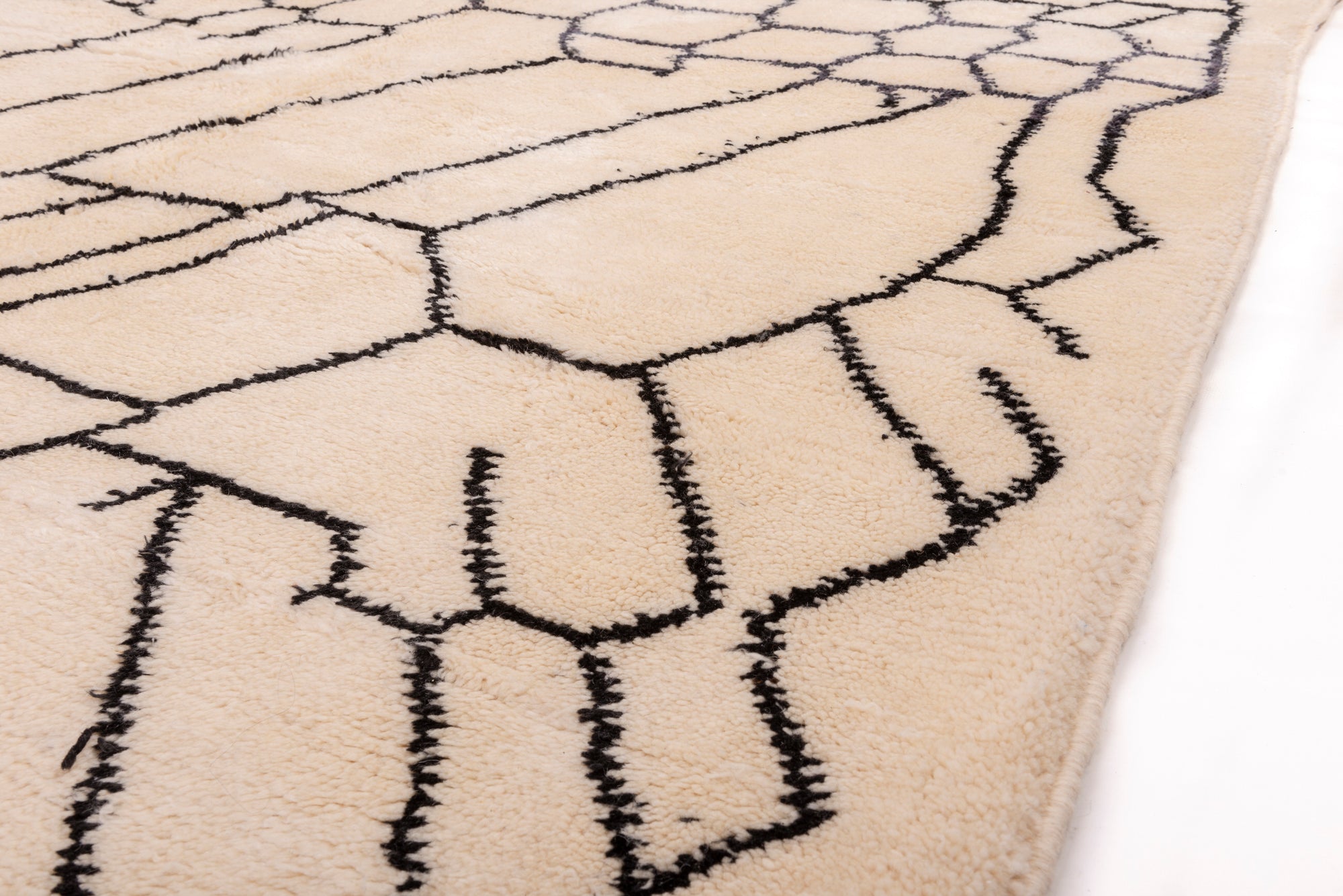 Elevate your space with our 'Ivory Infinite Net Beni Ourain Rug.' Featuring an exquisite ivory base adorned with an abstract net pattern, this rug effortlessly combines classic elegance with modern allure. Handcrafted with precision, it adds a touch of sophistication to any room. Discover the timeless charm of this one-of-a-kind rug today.