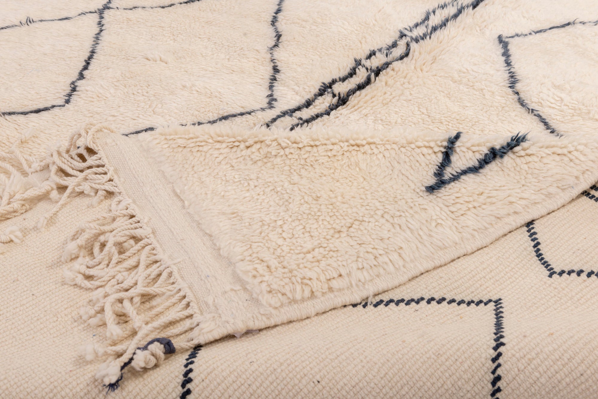 Enhance your space with our Ivory Geometric Maze Rug. This captivating piece features an ivory base adorned with an abstract irregular crisscross pattern and small black squares at the top, adding intrigue and sophistication to your decor.