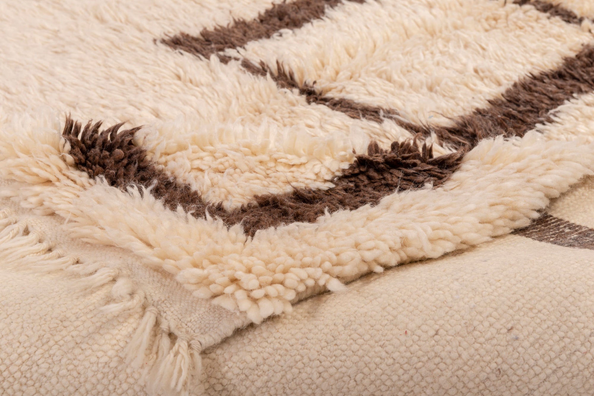 Elevate your decor with our 'Ivory Square Frame Beni Ourain Rug.' Featuring an ivory base with a small square frame in rich brown at the center, and a broader brown border at the edges, this rug exudes minimalistic elegance that's perfect for enhancing your space.
