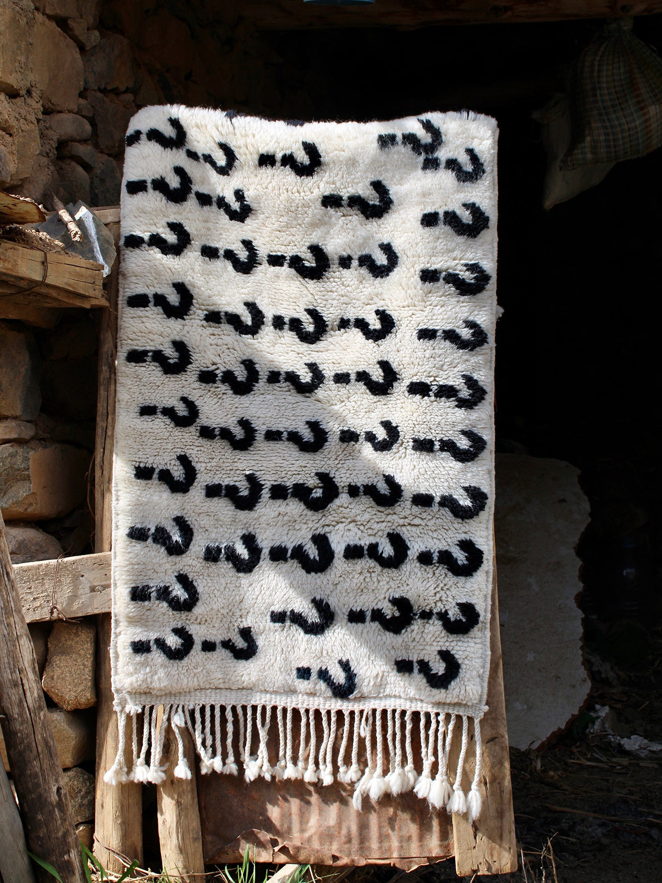 Experience the ultimate comfort with our 'Ivory Enigma Rug: Super Soft Playful Question Marks in Black Yarn.' Crafted for coziness, this rug showcases a delightful pattern of playful question marks in black yarn on an ivory background. Its irresistibly fuzzy texture adds a touch of luxury to any space, making it a perfect addition to your home. Elevate your décor with this charming blend of softness and whimsy.