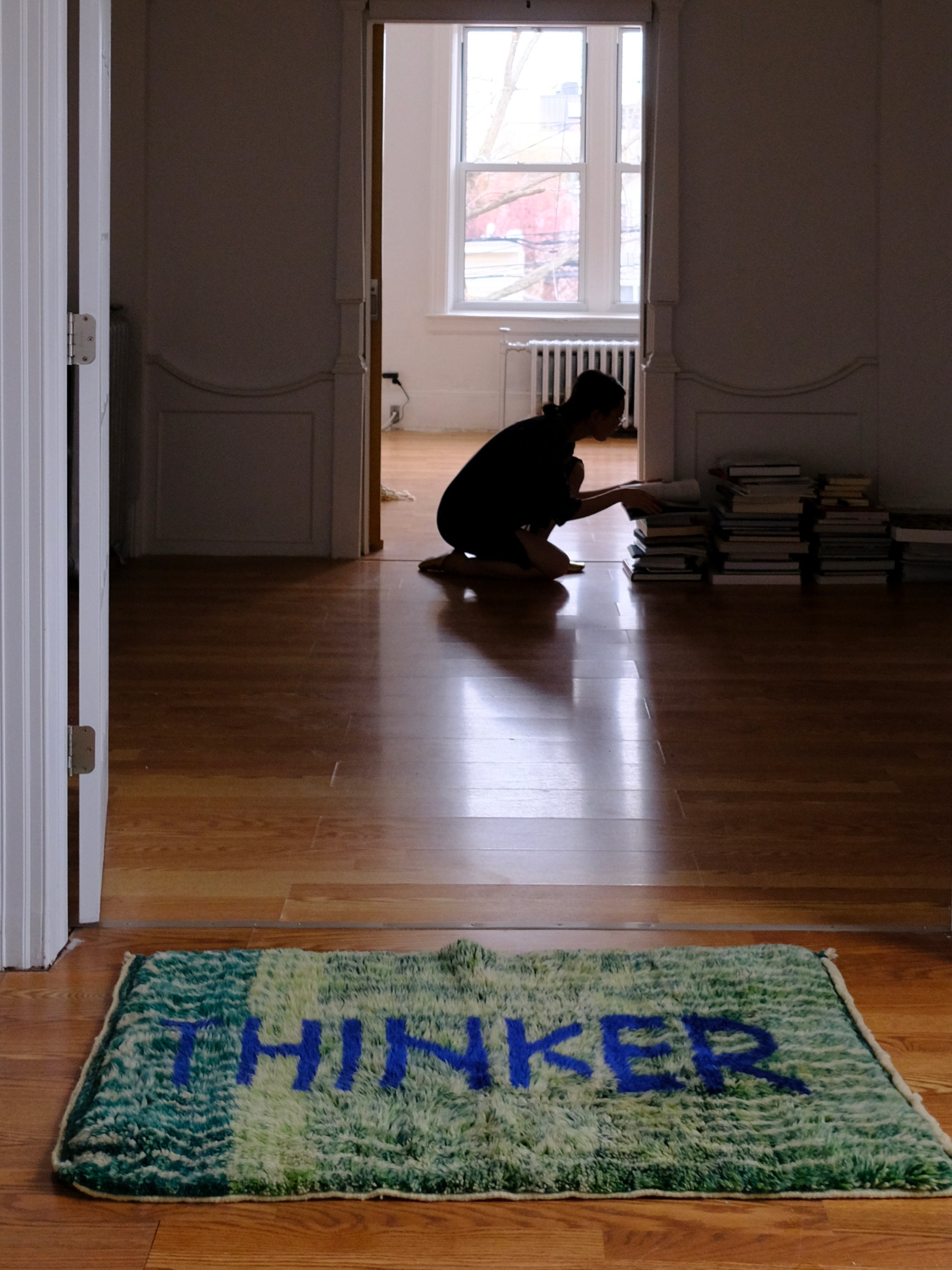 Introducing the 'Verdant Thinker Rug,' where the profound 'Thinker' letter is meticulously woven in blue yarn. Set against a backdrop of unique green and ivory curved wave lines, this rug brings a touch of intellectual charm to your space. Elevate your home with its artistic blend of colors and textures, creating a vibrant and thoughtful ambiance that resonates with modern sophistication.