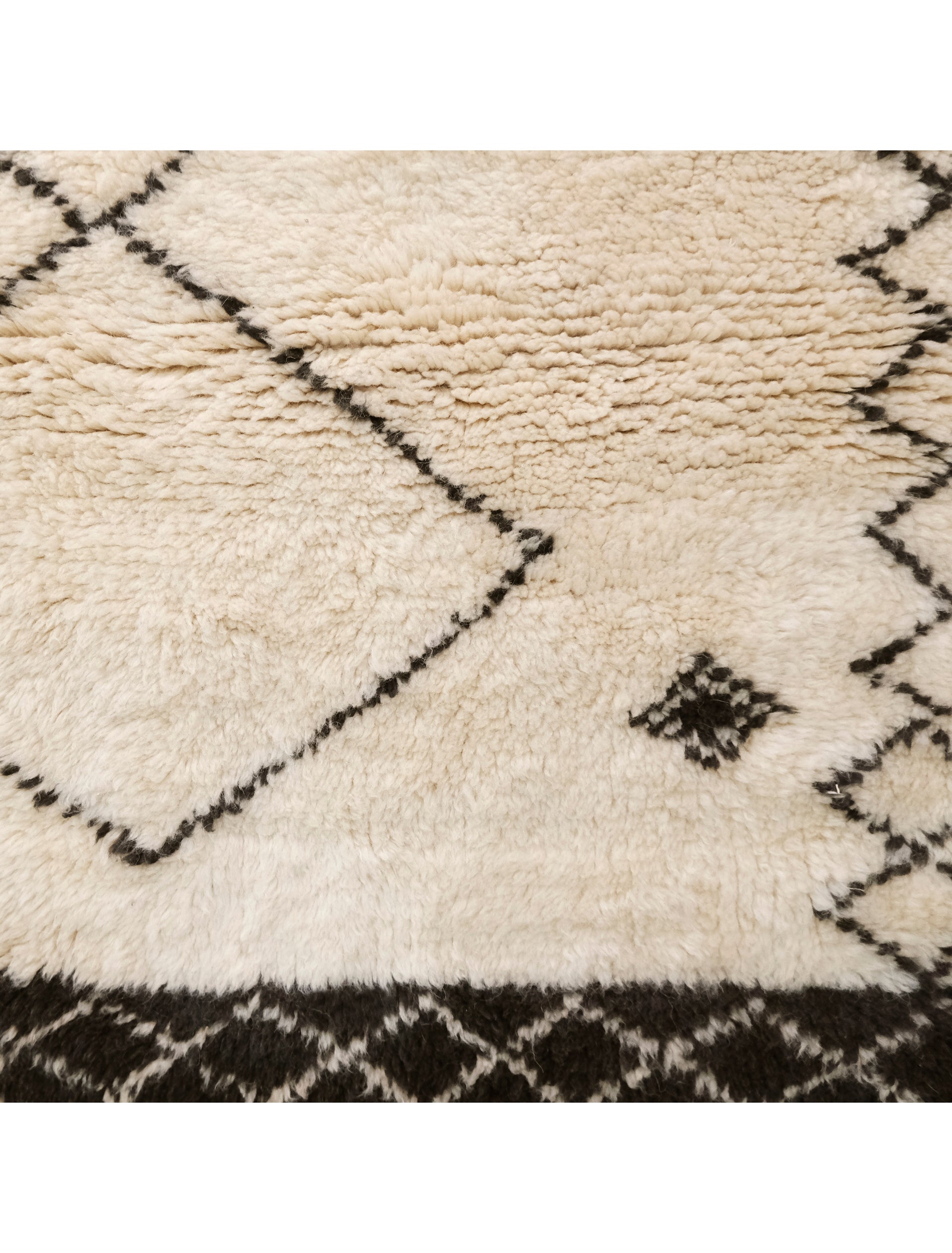 Discover elegance with our "Monochrome Diamond Ensemble" Beni Ourain Rug, sized at 3.7 x 4.9 feet. Its ivory base features three prominent diamond shapes in a delicate black outline at the center, complemented by two rows of smaller diamonds on each side. Meticulously crafted, this rug effortlessly blends tradition and modern design, making it a versatile and captivating addition to any space. Elevate your home with timeless Berber beauty.